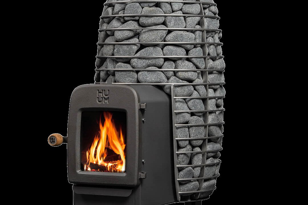 HUUM wood-burning sauna stove with a fire burning behind the glass door