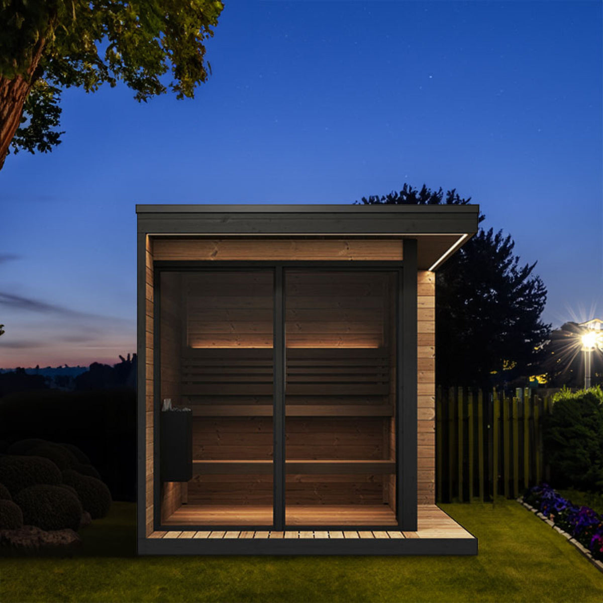 SaunaLife GL6 sauna at night with illuminated eaves and interior lighting