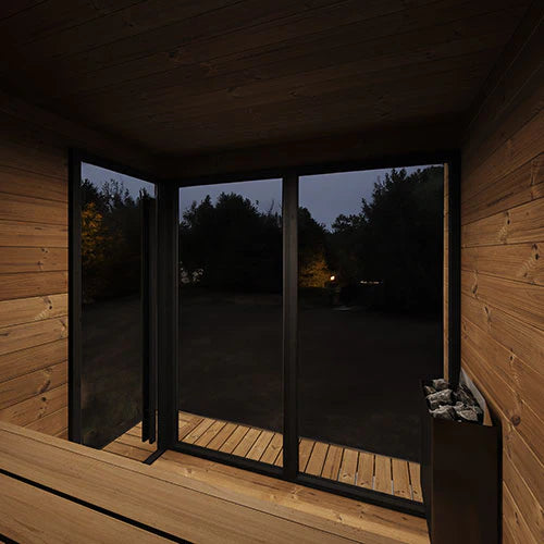 SaunaLife GL6 interior view at night looking out through the glass front