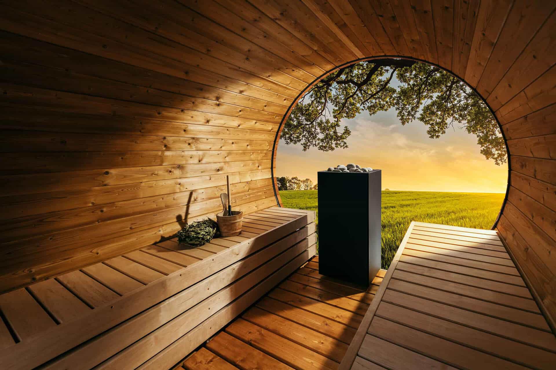 Wooden sauna with a circular window overlooking a field and tree
