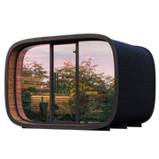 Modern outdoor pod with glass panels showing a garden view.