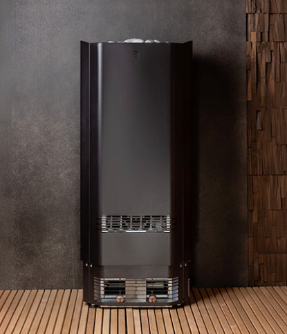 Modern black freestanding shower unit against a dark wall with wooden floor.