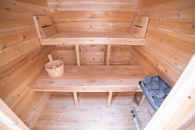 Interior of the Granby sauna with two-tier cedar benches and an electric heater.