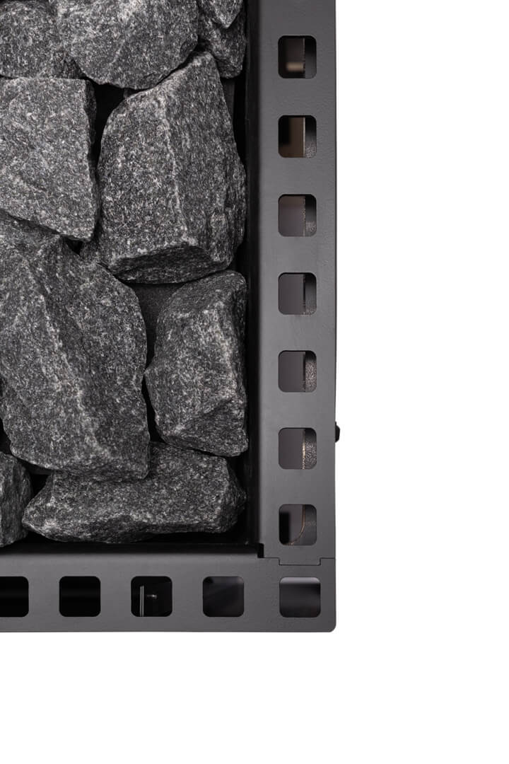 Stack of gray stones in a black metal basket on a white background